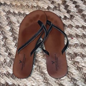 American eagle black and silver detail flip flops